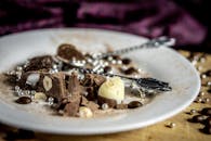 Gourmet chocolate dessert with hazel nuts on a plate. Indulgent and artistic food photography.